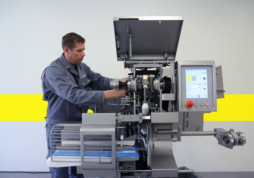 Service employee working on clipping machine 